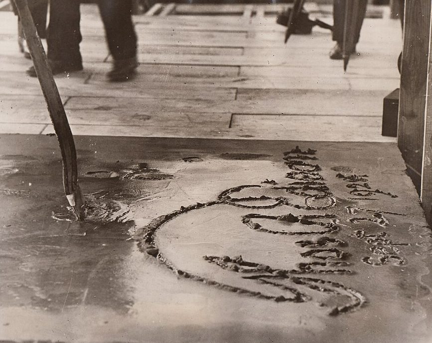 Cement block bearing Thomas Edison's signature and Luther Burbank's spade pressed into the wet surface, 1915